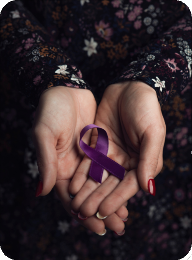 A picture of a pair of hands holding a purple ribbon that has been crossed
