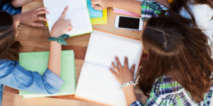 bird's eye view of students working; cell phones on the table