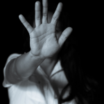 woman putting hand up to camera indicating stop