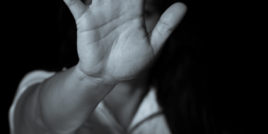 woman putting hand up to camera indicating stop