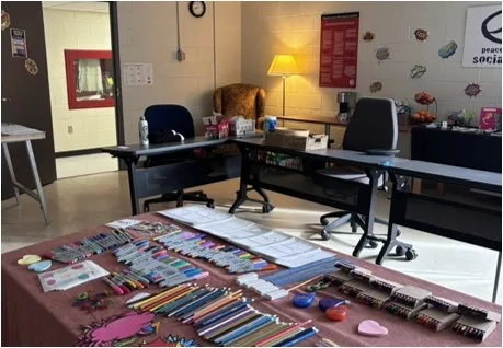 table with art materials, low lighting